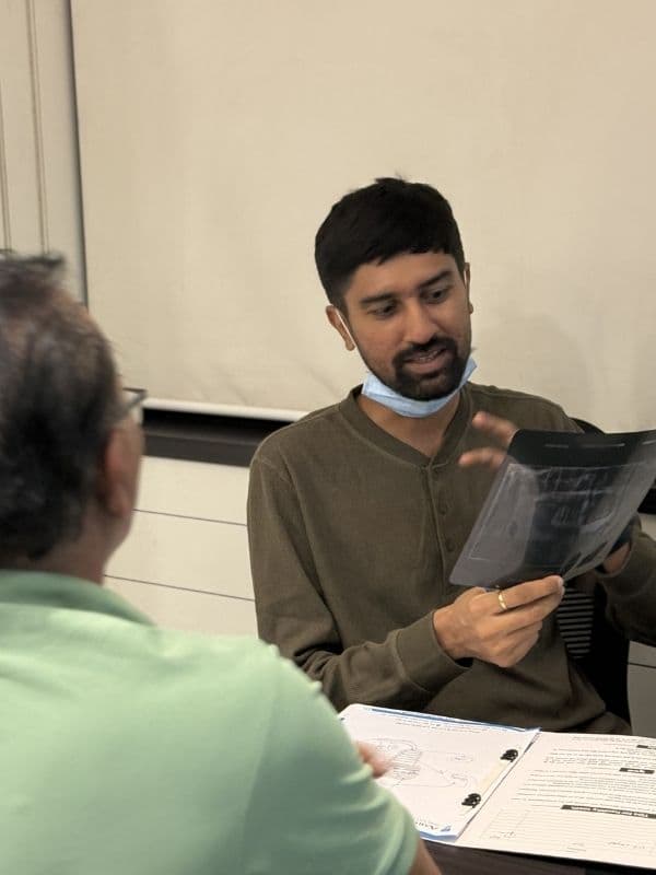 Dr. Pratik Pipalia reviewing dental X-rays with a patient
